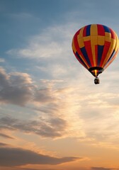 Fototapeta premium Colorful hot air balloon soaring in the sky at sunset