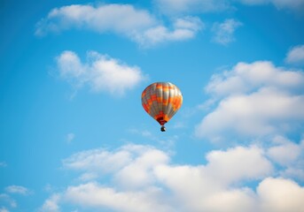 Fototapeta premium Colorful hot air balloon soaring through a clear blue sky