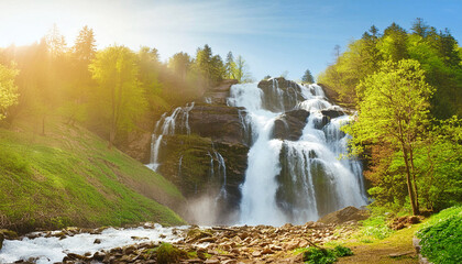 Fototapeta premium Large, majestic waterfall in sunlit mist. AI