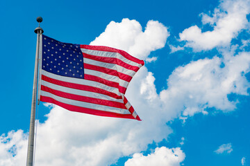 Flag of the USA. National waving flag of united states on blue sky. Independence day. Patriotic symbol. American Flag for Memorial Day or 4th of July. American flag. Day of independence