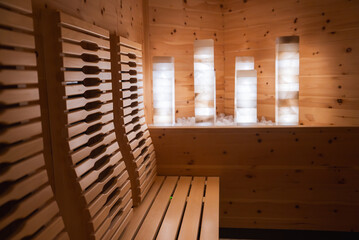 Light toned wood paneling and ergonomic seating define this sauna, featuring illuminated...