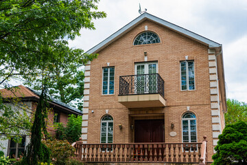 House exterior architecture. Housing in neighborhood. Private house architecture. Private housing property. Residential suburban house. Suburban home in private residential housing. Real estate