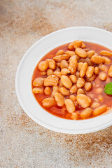 White bean tomato sauce gourmet food background on the table rustic food top view copy space