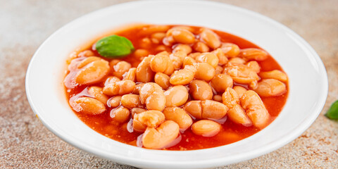 White bean tomato sauce gourmet food background on the table rustic food top view copy space