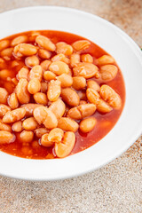 White bean tomato sauce gourmet food background on the table rustic food top view copy space