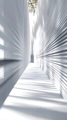 Obraz premium A serene passageway bathed in sunlight, where light and shadow dance between sleek, white walls creating a peaceful, minimalist atmosphere.