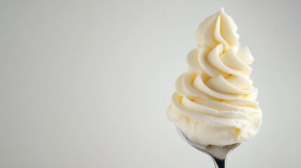 Creamy swirls of frosting on a spoon