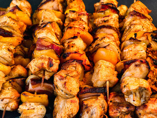 Grilled chicken kebabs with vegetables, homemade BBQ skewers, fresh marinated meat and bell peppers closeup