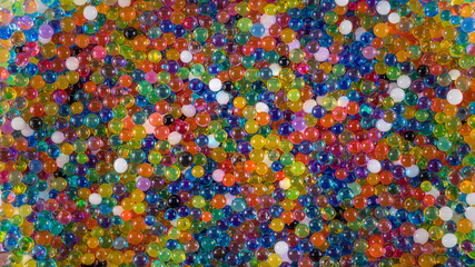 Water beads close-up, abstract background. Texture of Hydrogel balls or many colorful orbeez for wallpaper.