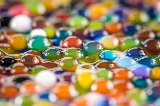 Water beads close-up, abstract background. Texture of Hydrogel balls or many colorful orbeez for wallpaper.