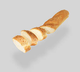 Pieces of freshly baked baguette in air on light grey background