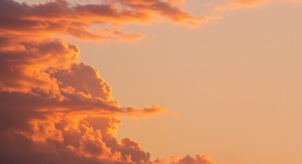 Fototapeta premium Sunset Clouds with Soft Orange Hues Highlighting Cotton-Like Forms in a Serene Atmosphere