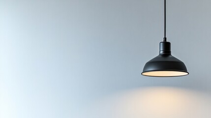 Obraz premium Minimalist Black Pendant Lamp Against a Light Blue Wall