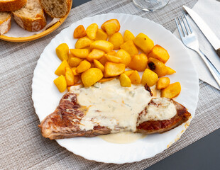 Bistec al roquefor, grilled roquefort steak with gravy cheese and sliced potato