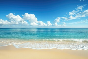 Fototapeta premium Tropical beach scene, calm waves on golden sand, clear sky with puffy clouds. Perfect for travel, vacation, or relaxation