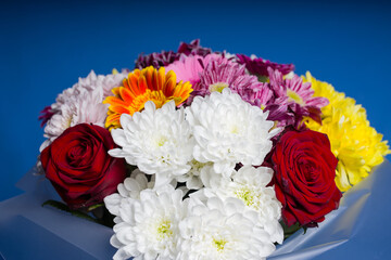 a bouquet of flowers on a blue background, presented for a holiday. Flower shop