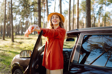 Beautiful woman near car and enjoy the nature around - concept of off grid vacation and trip with...