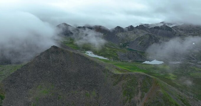 Aerial footage of beautiful high altitude grassland and mountain landscape