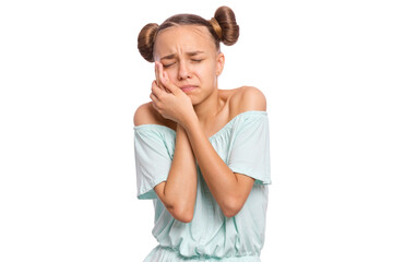A young girl with pigtails showing a sad expression while holding her face.