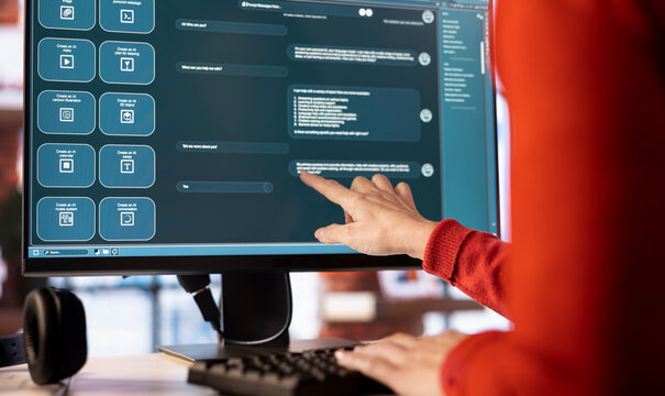 Woman uses AI chatbot system on a computer to guide her through problem solving tasks, futuristic technology highlights smart algorithms and machine learning. Online communication and support.