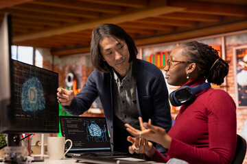 AI startup office chief technology officer overseeing programmer building application. Senior...