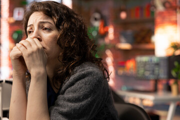 Stock market expert being worried and disappointed with the stock market crash, following financial trends on her PC and crying. Young woman exasperated and devastated about monetary losses.
