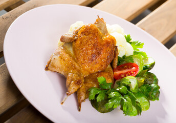 Whole fried quail served with steamed cauliflower and brussel sprouts