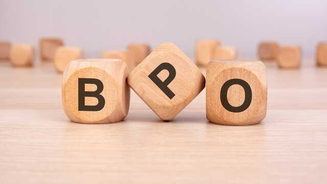 wooden blocks with the letters "BPO" on a wooden surface, representing Business Process Outsourcing