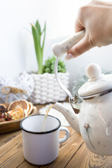 Enameled teapot with gooseberries, cranberries and cinnamon sticks. Spicy aromatic tea