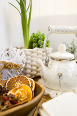 Enameled teapot with gooseberries, cranberries and cinnamon sticks. Spicy aromatic tea