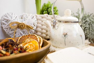 Enameled teapot with gooseberries, cranberries and cinnamon sticks. Spicy aromatic tea