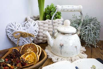 Enameled teapot with gooseberries, cranberries and cinnamon sticks. Spicy aromatic tea