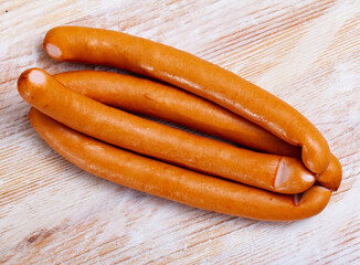 Appetizing czech chicken sausages on wooden table