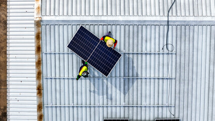 A sustainable energy project featuring solar panels on a roof surrounded by tropical trees,...