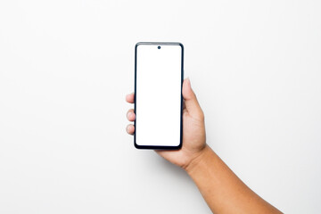 Close up of hand holding modern smart phone mockup. New modern black frameless smartphone mockup with blank white screen. Isolated on white background high quality studio shot Modern smart