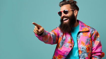 A jubilant bearded man in vibrant floral attire points playfully, radiating summer joy against a serene teal backdrop.