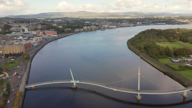 City of Derry aka Londonderry in Northern Ireland aerial view - A Beautiful Cityscape from above by the River Foyle Featuring the Beautiful Pedestrian Peace Bridge