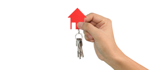 Hand holding red house keychain real estate transaction indoor setting bright environment close-up view home ownership concept