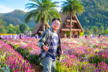 Asian tourists in a Japanese-style flower garden in Hokkaido