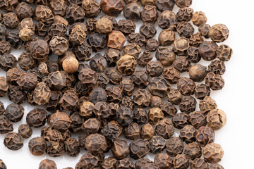 Capture the intense aroma and bold flavor with this detailed close-up of black peppercorns. 