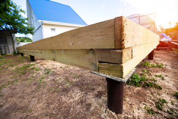 Wooden frame house foundation on screw piles
