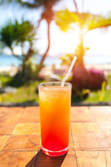 Orange Fruit shake cocktail with ice and straw in it, tropical vacation. Summer holidays