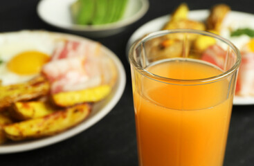 Tasty brunch. Refreshing drink and dishes on dark table, closeup