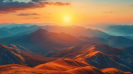 The sun rises over the mountains in the early morning, casting a warm golden glow across the rugged peaks and creating a serene and peaceful atmosphere. 