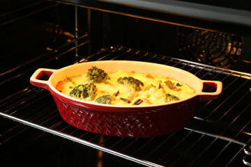 Baking dish with delicious vegetable casserole in oven