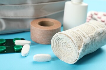 First aid kit on light blue background, closeup