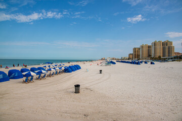 a gorgeous landscape at Clearwater Beach with hotels and palm trees along the beach and people walking in Clearwater Florida USA