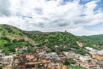 Fototapeta premium Amber Fort, a palace complex and military fortress in Amber, offers a stunning view of the Sun Gate, the Aravalli mountain range in the background, and the city wall.