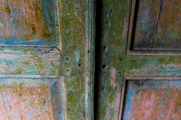 Old wooden door surface is naturally mossy close up detail, background wood pattern surface of the door.