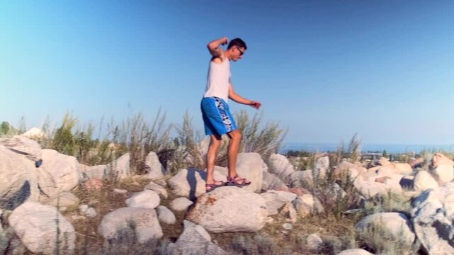 A crossfitter trains in rocky terrain, jumping over stones and obstacles. Challenging landscapes build strength, coordination, and endurance, enhancing fitness for intense workouts.